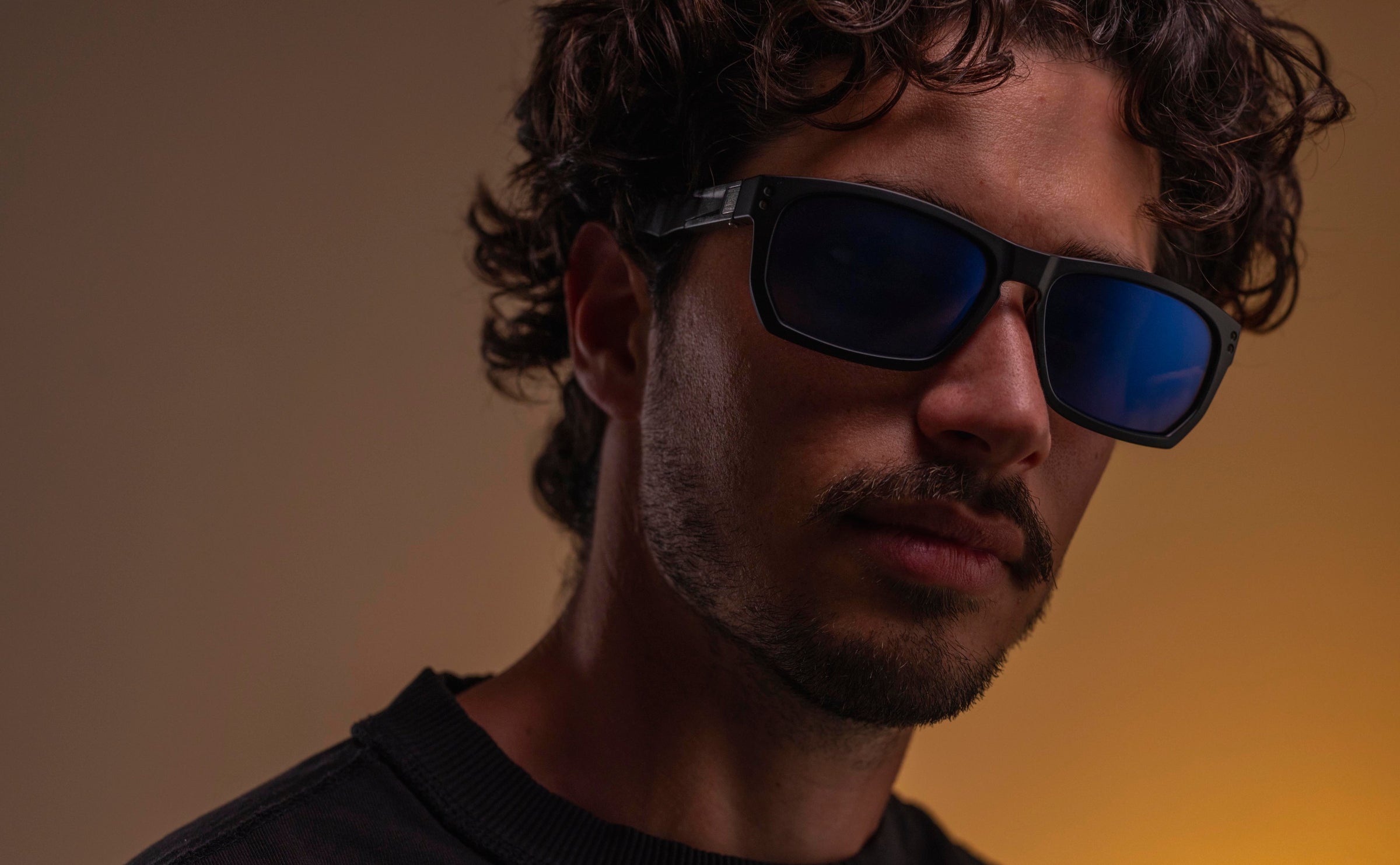 Man wearing sunglasses with a gradient background